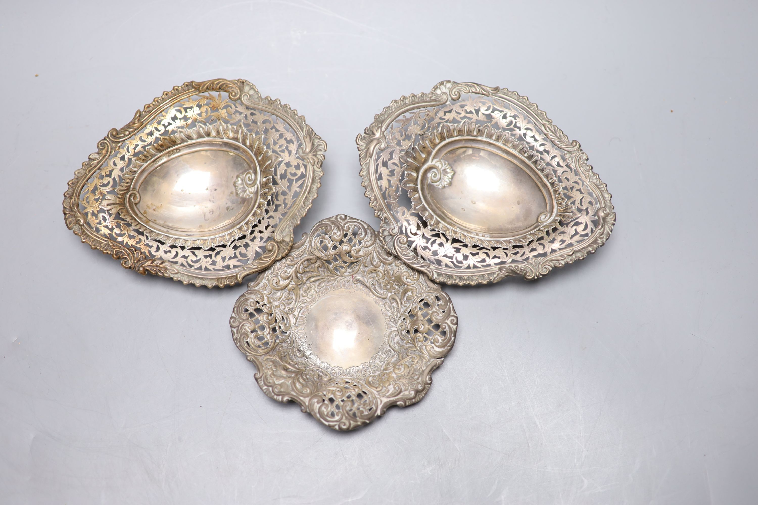 A pair of late Victorian silver shaped oval bonbon dishes, Birmingham, 1894, 13.9cm and one other pierced silver bonbon dish.